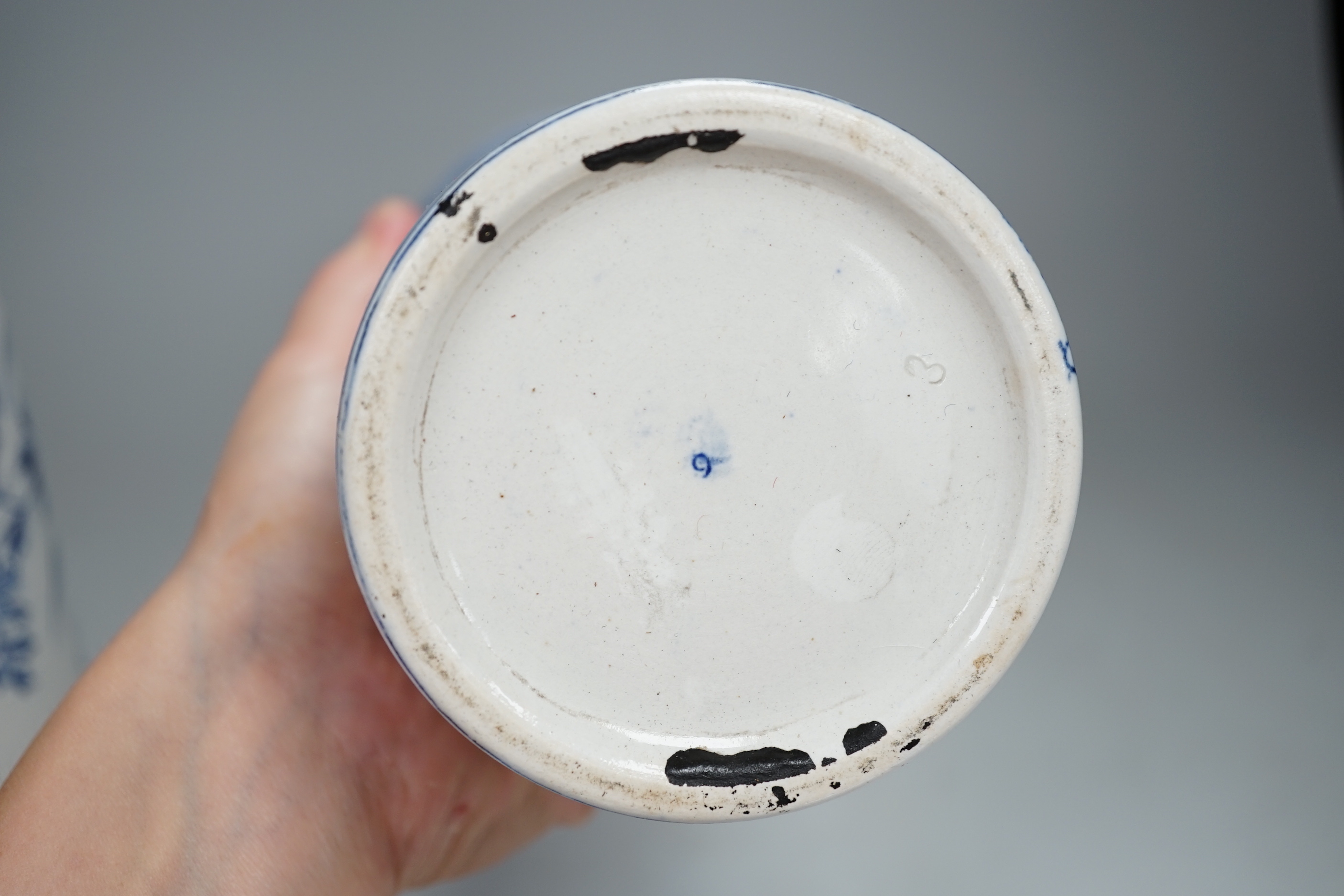 A pair of Delft blue and white cylindrical vases, each decorated with boats, 30cm high